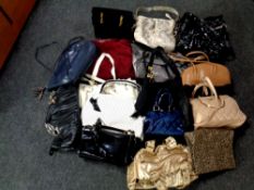 A box of lady's leather and fabric hand bags