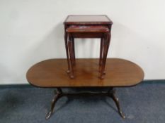 An oval inlaid mahogany coffee table and a nest of two tables
