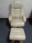 A wood framed cream leather manual reclining armchair with stool CONDITION REPORT: