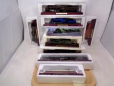 A tray of twelve Atlas Editions models of locomotives with accompanying magazines