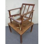A mid 20th century teak armchair and a square coffee table CONDITION REPORT: as