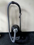 A Meile Power Plus 5000 vacuum cleaner with hose and accessories