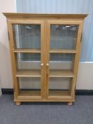 A stripped pine double door bookcase CONDITION REPORT: 101cm wide by 29cm deep by