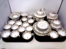 Thirty-five pieces of 19th century white and gilt tea china (two trays)