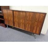 A mid 20th century rosewood triple sliding door sideboard on raised legs, height 95 cm,