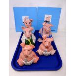 A tray of five Wade Natwest pigs together with two piggy bank statement holders