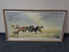 A framed oil on canvas : galloping horses