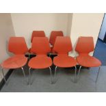 Six 20th century Danish stacking chairs upholstered in a red fabric on tubular metal legs