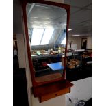 A mid 20th century teak framed hall mirror fitted with a shelf and drawer beneath