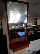 A mid 20th century teak framed hall mirror fitted with a shelf and drawer beneath