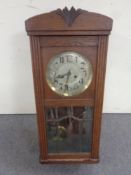 An early 20th century oak cased eight day wall clock with silvered dial,