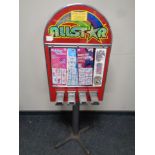 An All Star coin operated tattoo dispensing machine on four way pedestal