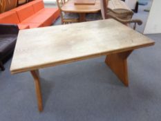 A blond oak extending refectory dining table