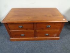 An Indonesian hardwood coffee table fitted four drawers