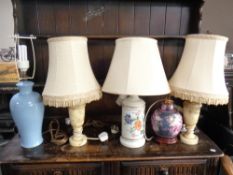 Three ceramic table lamps and a pair of marble table lamps all with shades