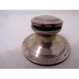 A small silver inkwell with glass liner,