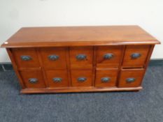 A stained pine ten drawer low chest