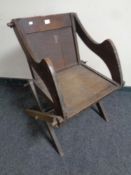 An antique oak church armchair
