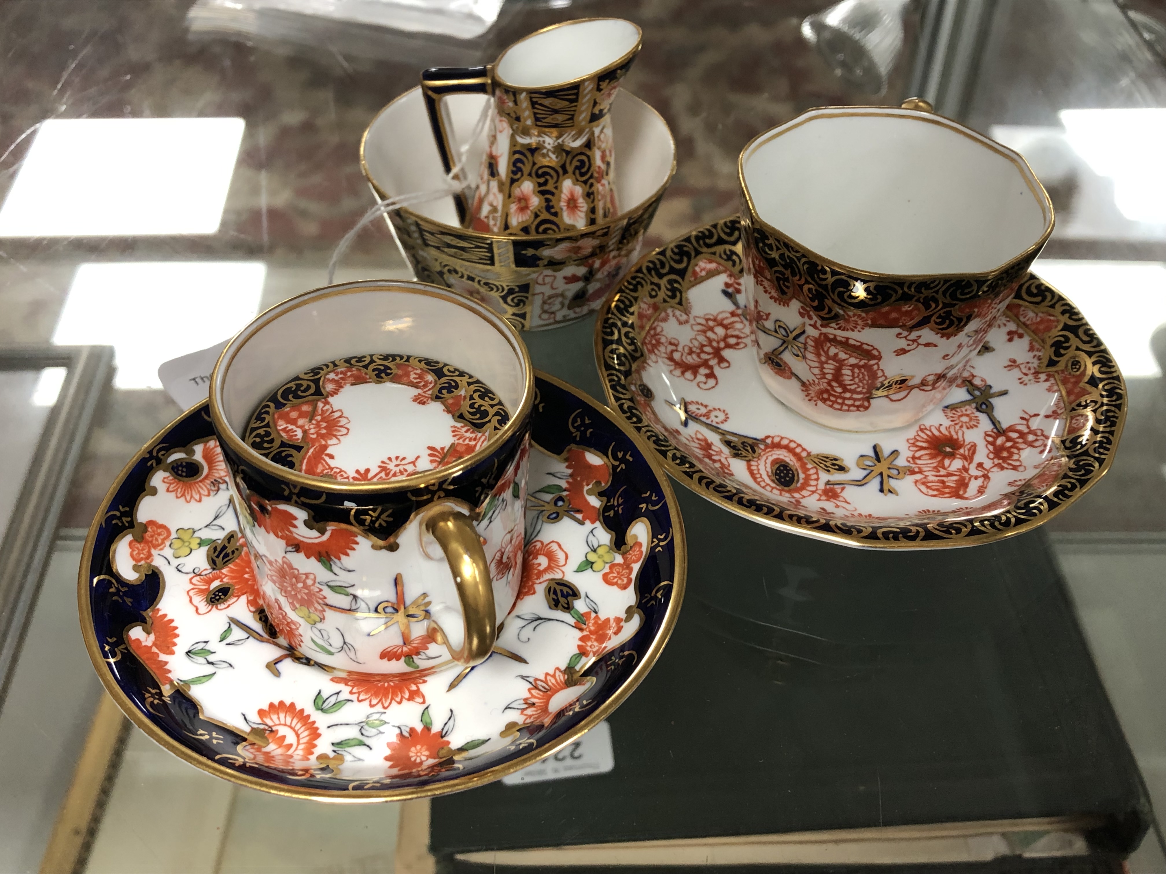 A Royal Crown Derby Imari pattern miniature sugar bowl and cream jug set, bowl height 4 cm,