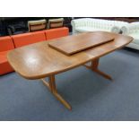 A mid 20th century Danish teak extending table with two leaves