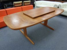 A mid 20th century Danish teak extending table with two leaves