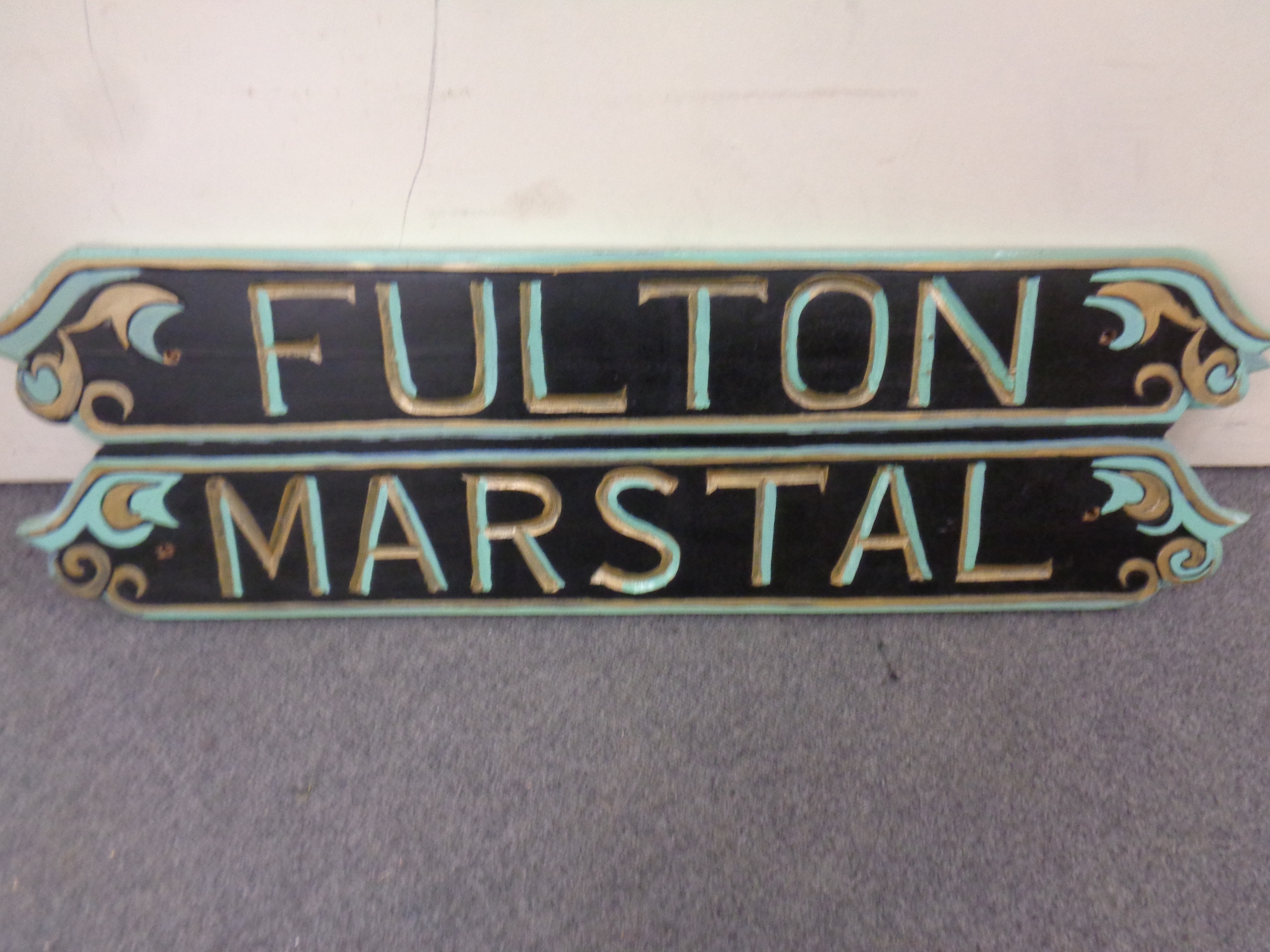 A hand painted wooden sign Fulton Marstal