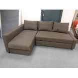 A contemporary corner bed settee in brown fabric