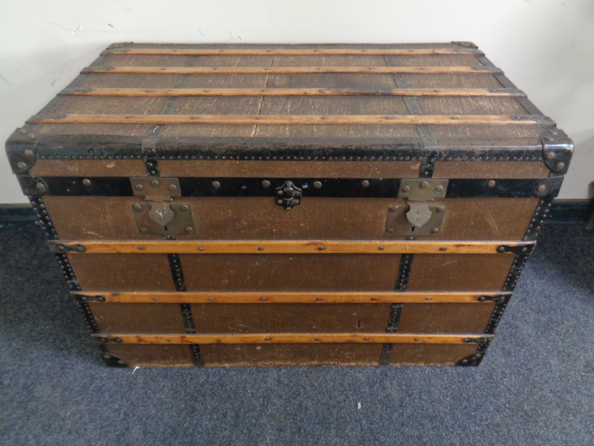 An early 20th century wooden bound shipping trunk