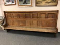 An oak high backed church pew,