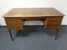 A mid 20th century Scandinavian walnut knee hole writing desk fitted six drawers