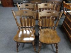 A set of four stained beech kitchen chairs