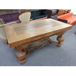 An early 20th century oak pull out dining table on heavy bulbous legs CONDITION REPORT: