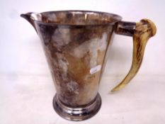 An antique plated jug with deer antler handle