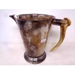 An antique plated jug with deer antler handle