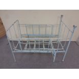 An antique cast iron adjustable painted cot bed