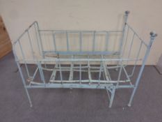 An antique cast iron adjustable painted cot bed