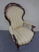 A 19th century mahogany framed armchair in cabriole legs