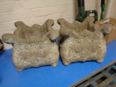 A pair of classical style concrete planters