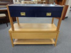 A contemporary television stand fitted a drawer in a blond oak finish,