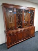 A mahogany four door glazed bookcase fitted cupboards beneath CONDITION REPORT: