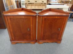 A pair of contemporary inlaid mahogany corner cupboards