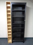 A set of Ikea open shelves and a media storage rack