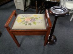 A 20th century tapestry upholstered piano stool containing sewing accessories and wool together