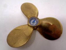 A miniature brass boat propeller compass,