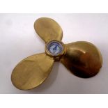 A miniature brass boat propeller compass,