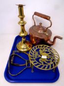 A tray of antique copper and brass wares to include copper kettle, brass trivet and candlestick,