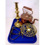 A tray of antique copper and brass wares to include copper kettle, brass trivet and candlestick,