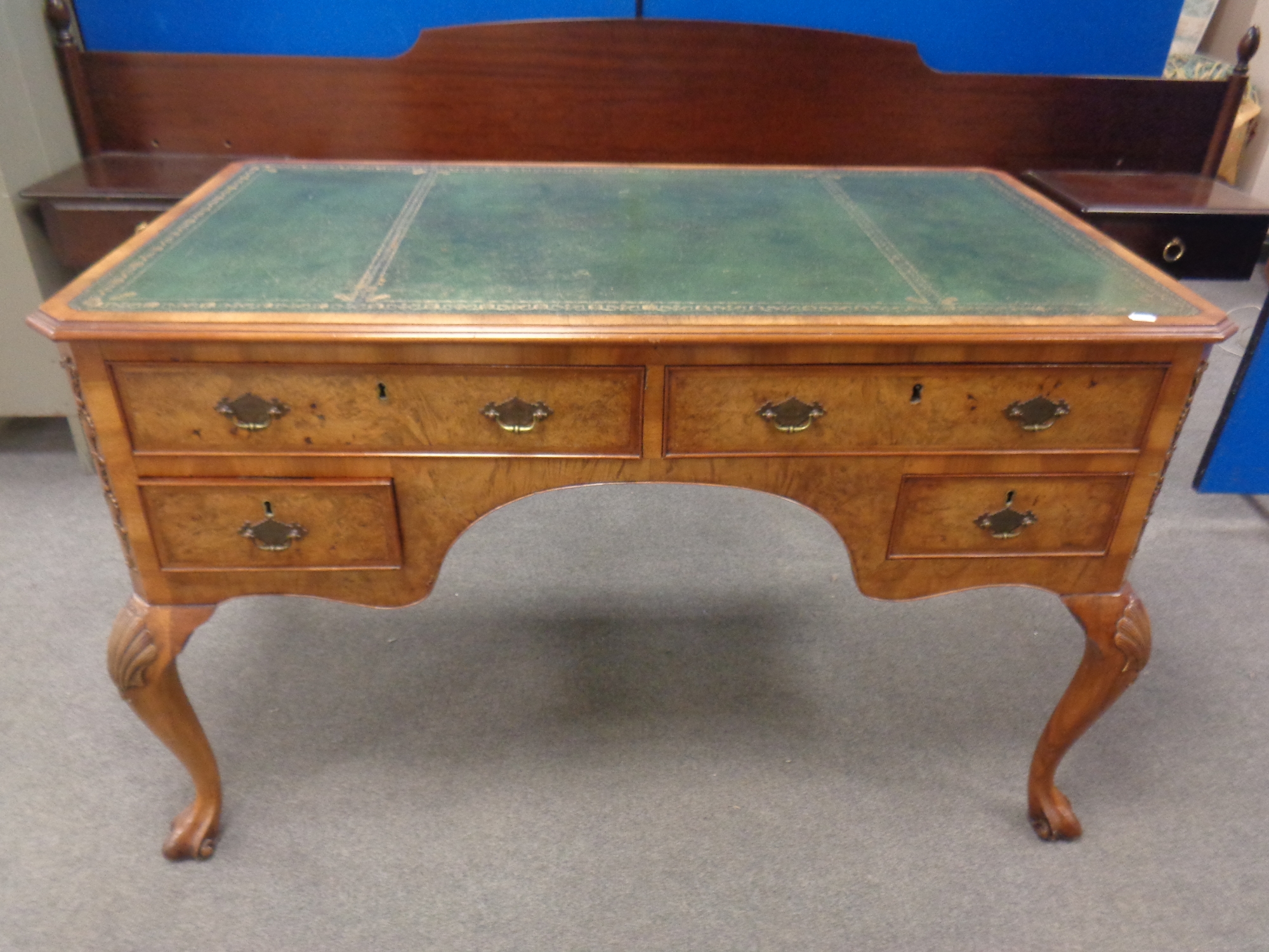 A burr walnut leather topped writing desk fitted four drawers