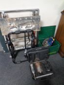 A metal tool box continuing Ryobi cordless vacuum, saw blades, cased masonry pieces,