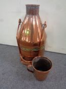 An antique Scandinavian copper water boiler with handle and a copper mug